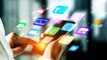 A person using a smartphone with colorful app icons floating around.