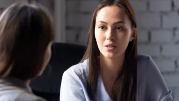 Two people having a conversation in a casual setting