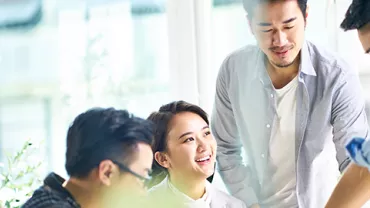 Group of people having a discussion in a bright office space.