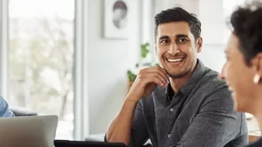 Group of people having a meeting in a bright office setting.