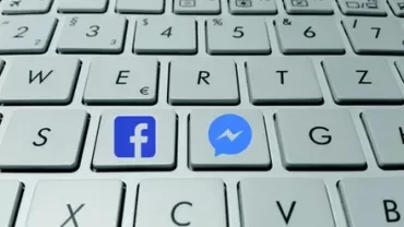 Close-up of a computer keyboard with Facebook and Messenger keys.