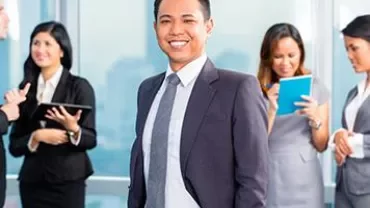 Business professionals interacting in a modern office setting.