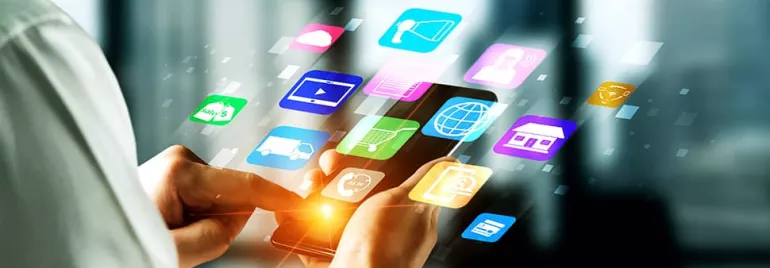 A person using a smartphone with colorful app icons floating around.