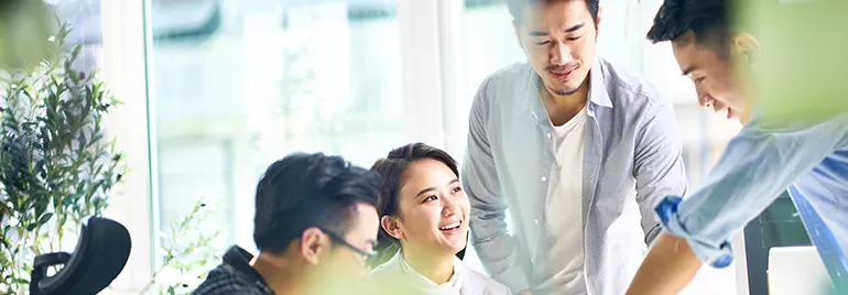 Group of people having a discussion in a bright office space.