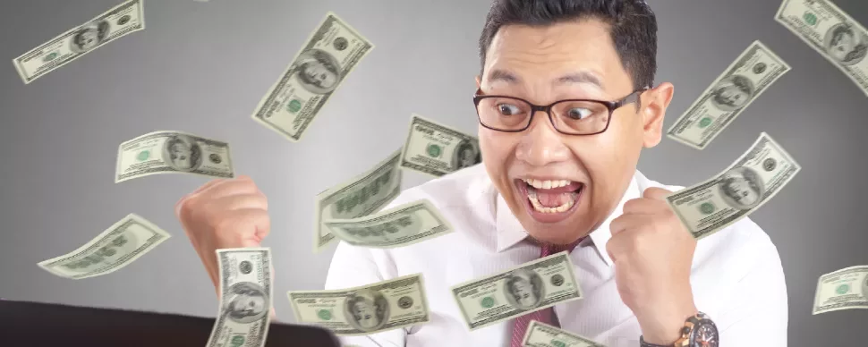 Excited person with glasses surrounded by falling dollar bills.