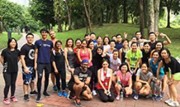 Group of people posing together in a park.