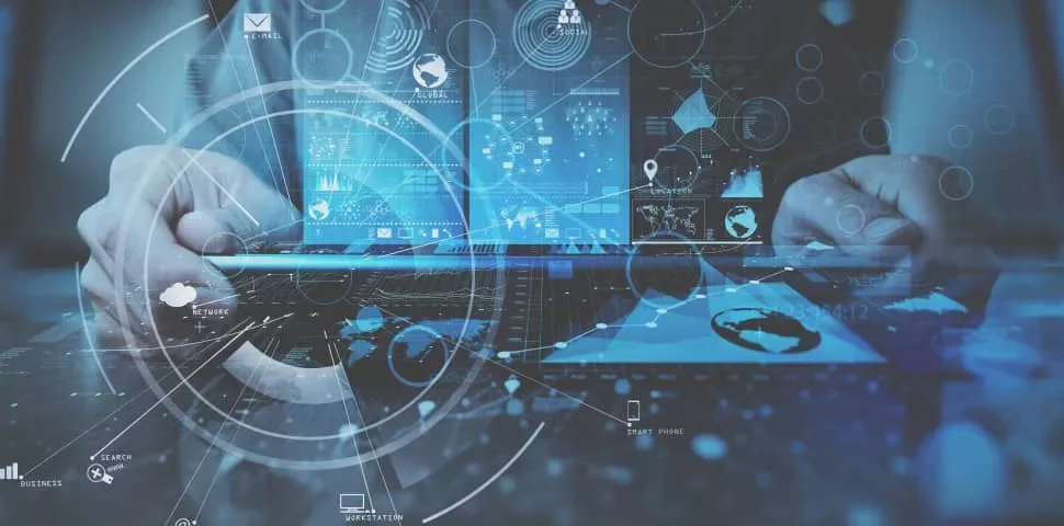 Person using laptop with digital interface overlay displaying graphs and network icons.