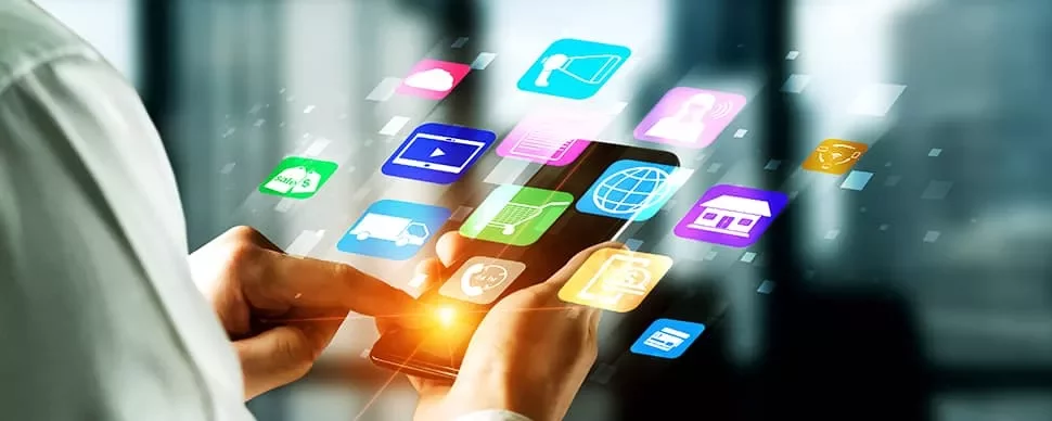 A person using a smartphone with colorful app icons floating around.