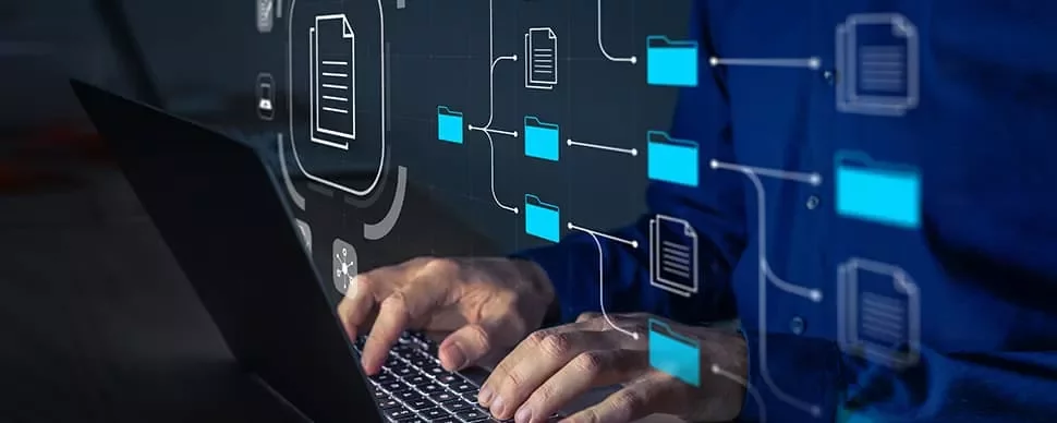 Person using a laptop with digital file icons and connections overlayed.