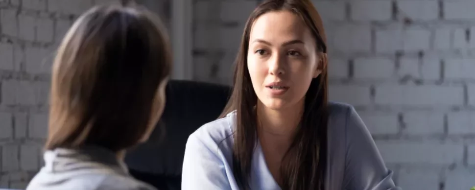 Two people having a conversation in a casual setting