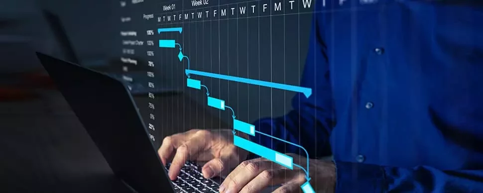 Person typing on a laptop with a Gantt chart displayed on screen.