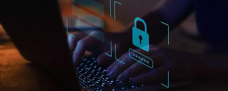 Hands typing on a laptop keyboard with a digital security padlock icon.