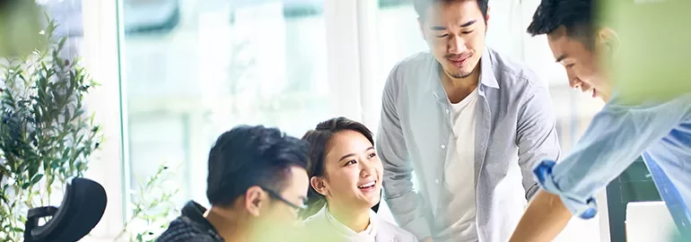 Group of people having a discussion in a bright office space.