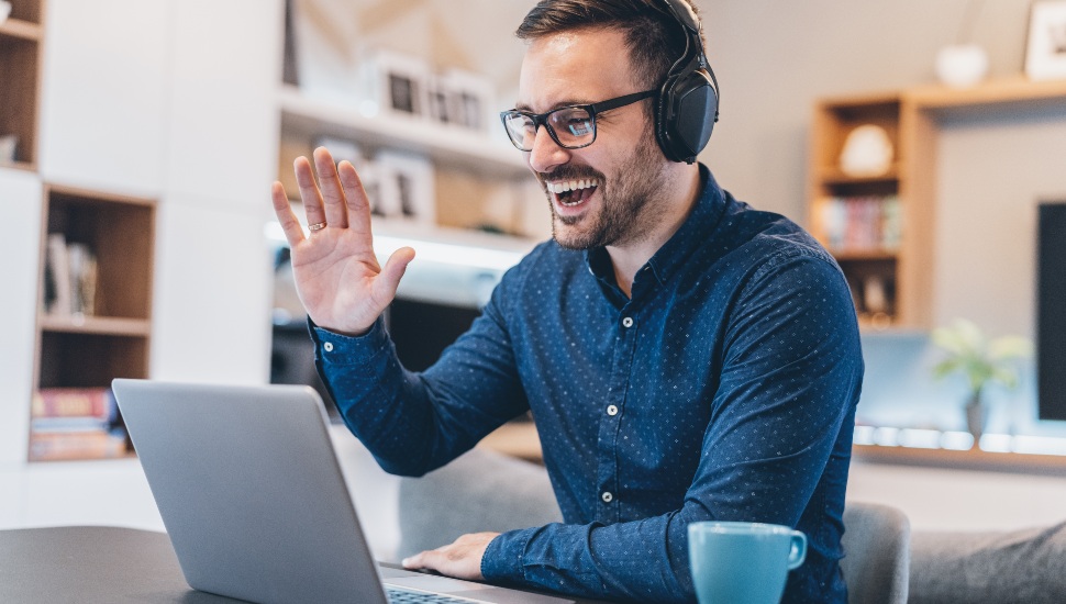 Guy-looking-at laptop-smiling