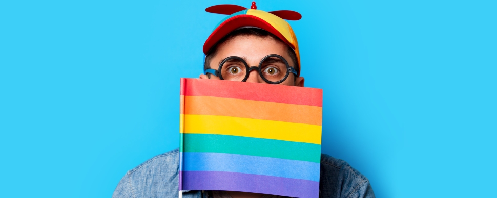 'Man carrying a rainbow flag that signifies support for LGBTQIA+ communities